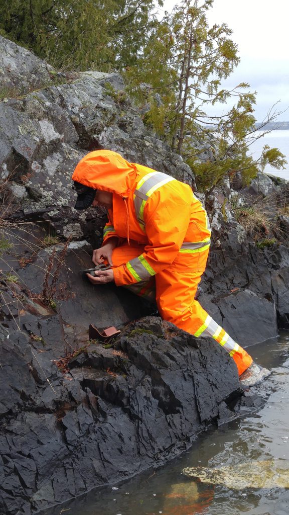 mineral exploration student compass reading on rock at Northern College
