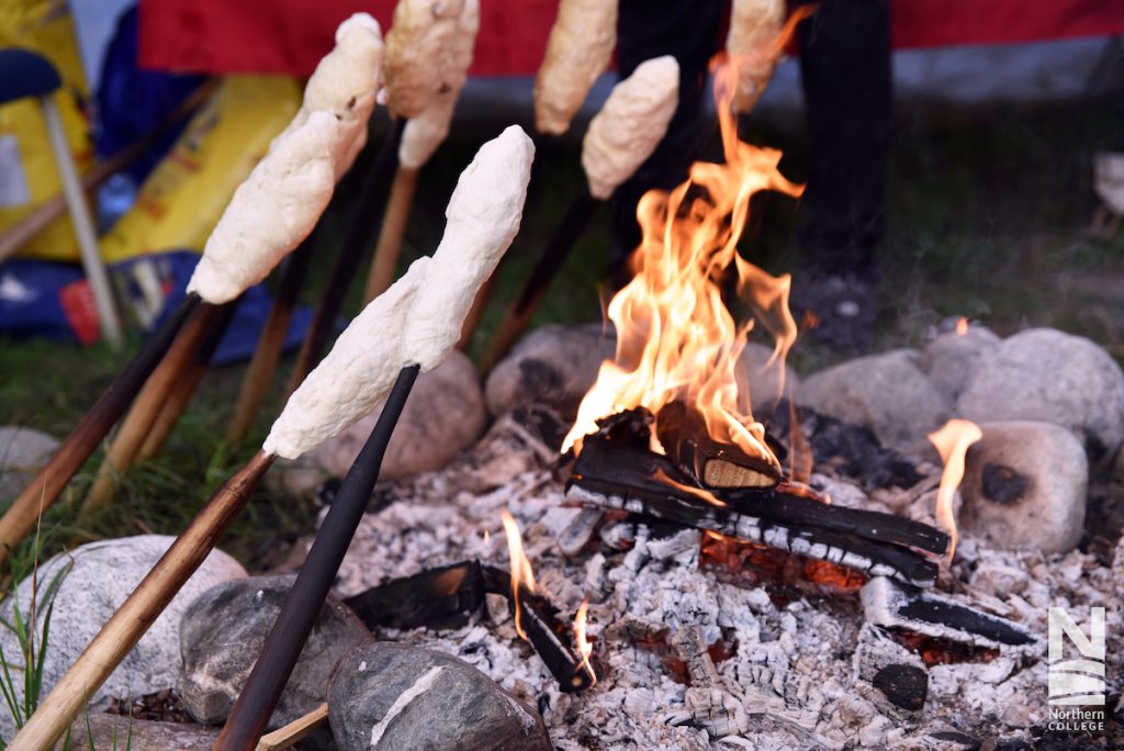 Northern College students Roasting Marshmallows at a bonfire