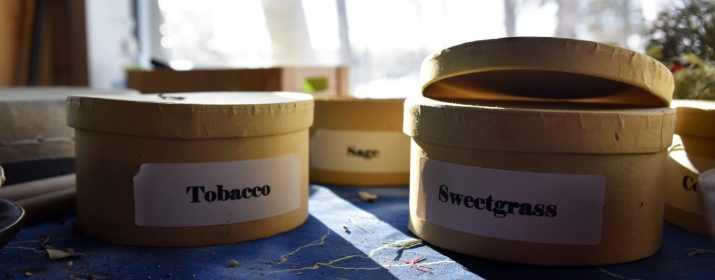 Photo of boxes of sage and sweetgrass used for smudging with indigenous student services department