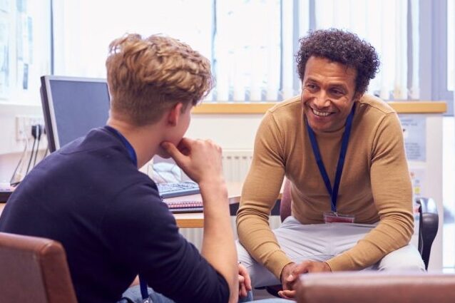 college student sits with advisor