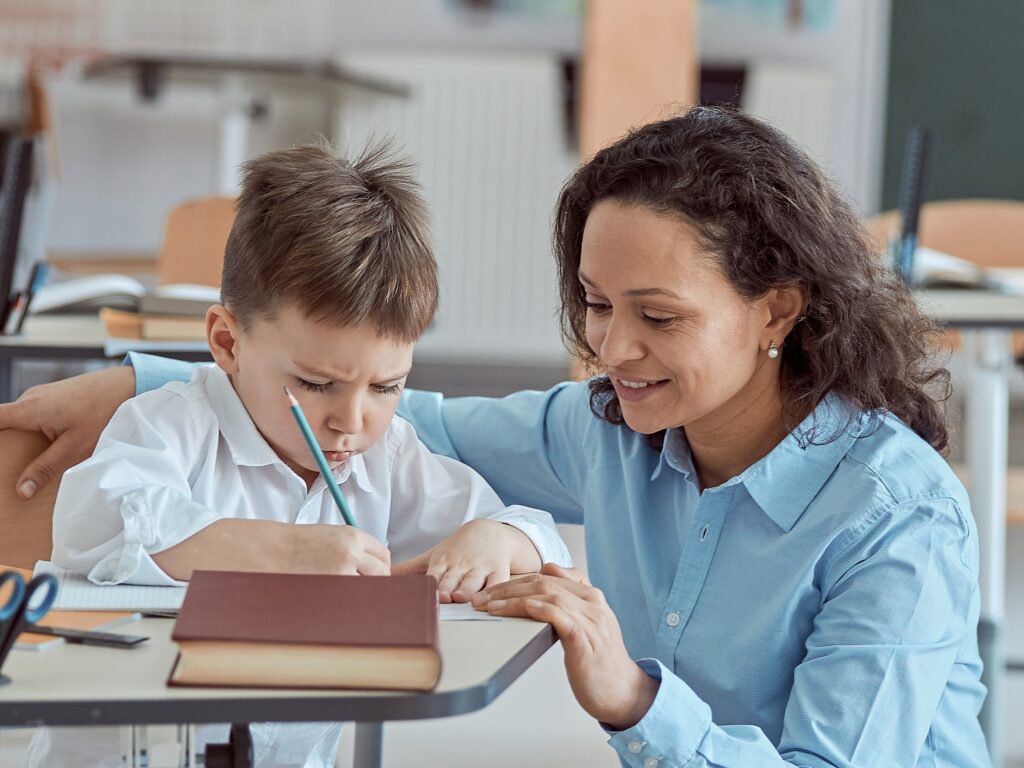 Educational Support Worker Program at Northern College - ECE worker with a young boy helping with homework