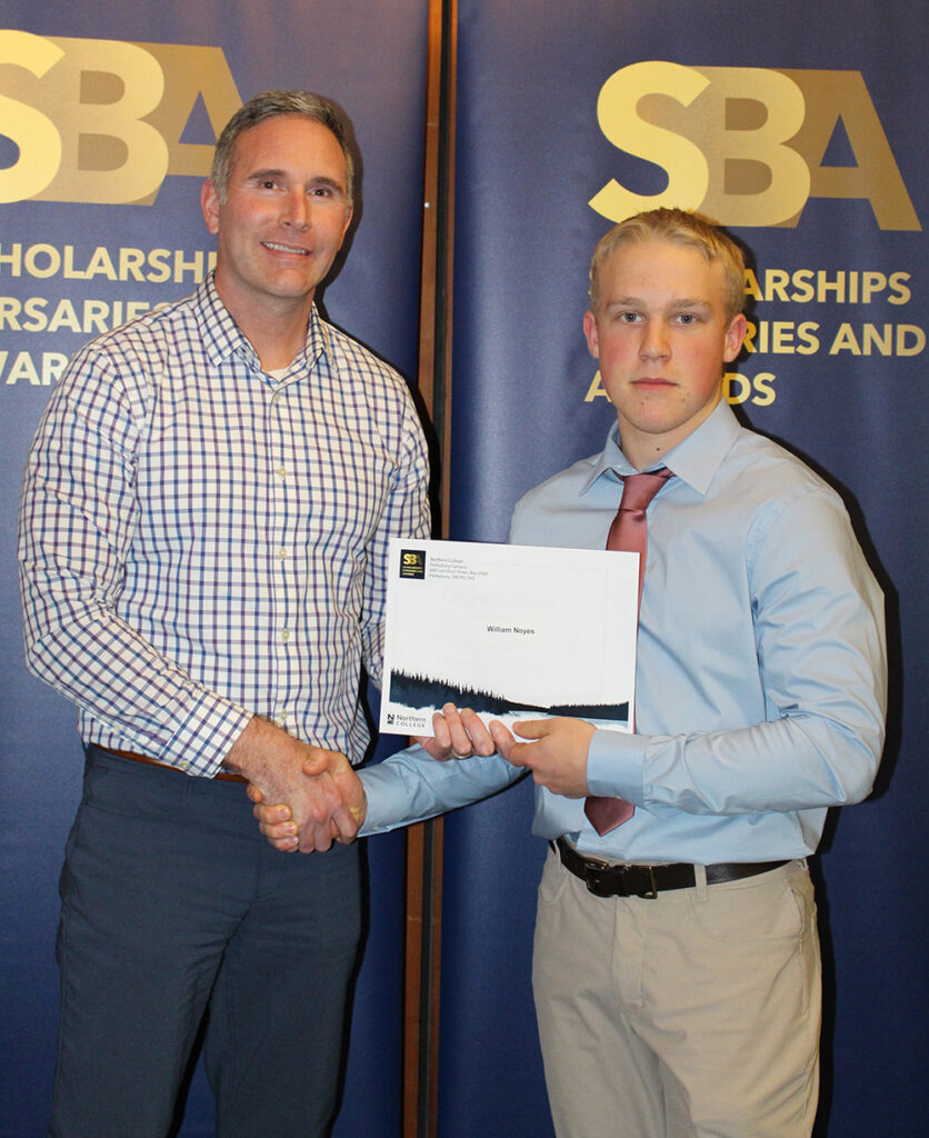Northern College President, Mitch Dumas presenting an award to a student at Haileybury Campus