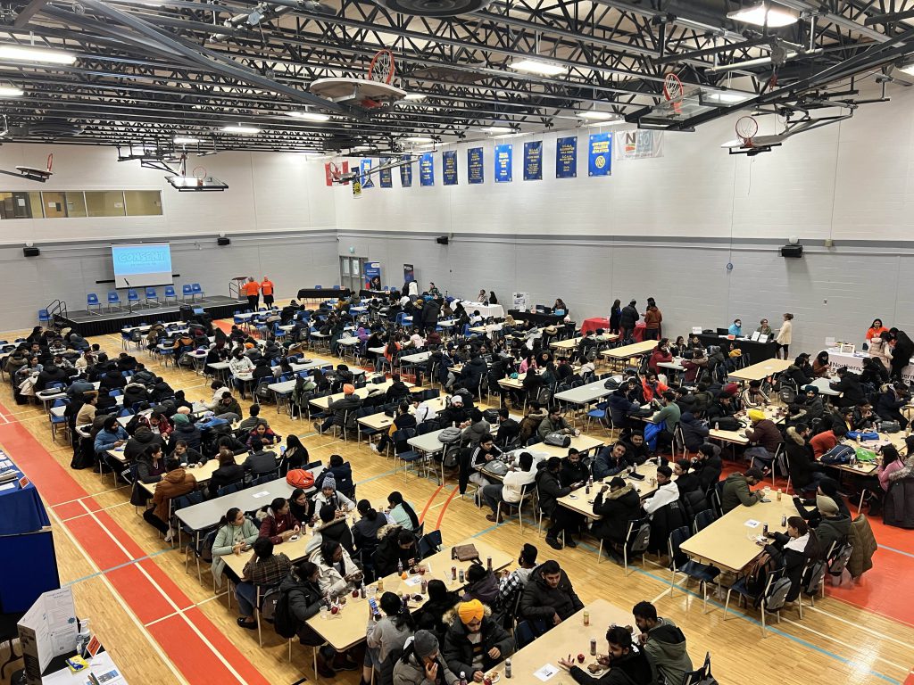 Picture of gymnasium full of students attending orientation day.