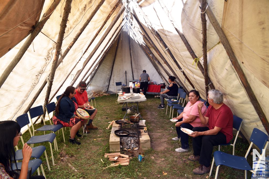 Photo of people in tipi during Indigenous Cultural Awareness Week