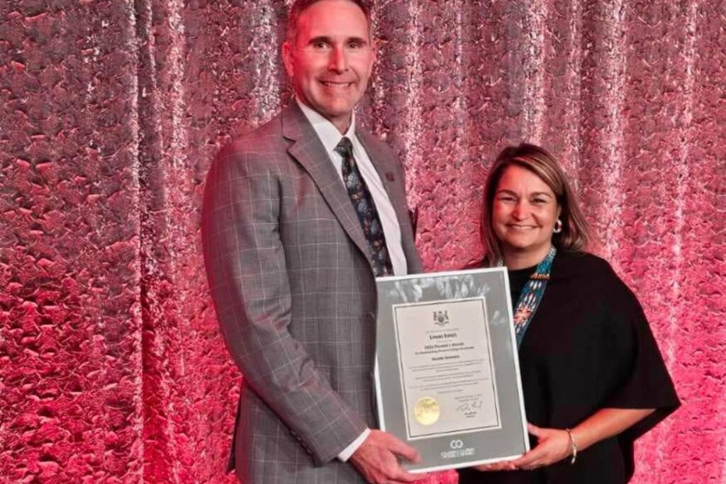 Lynne Innes receiving 2024 Premier's Award presented my Northern College president Mitch Dumas
