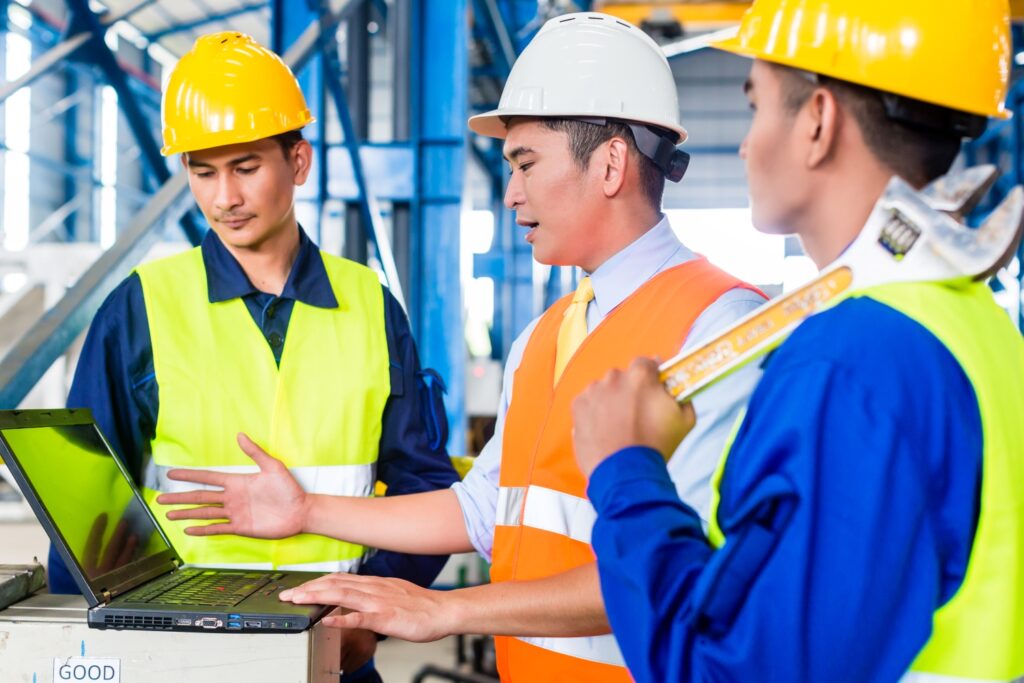 employees in factory doing online training at computer